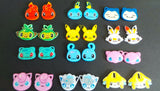 Selection of hand painted pokemon charms as either keychains, pin badges or jewellery sets