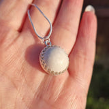 Ecopoxy Circle Breastmilk pendant with sterling silver bezel and chain, choice of opal glitters