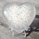 Lock of hair keepsake, baby's first curl, ecopoxy resin palm stone heart with a choice of opal glitters