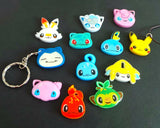 Selection of hand painted pokemon charms as either keychains, pin badges or jewellery sets